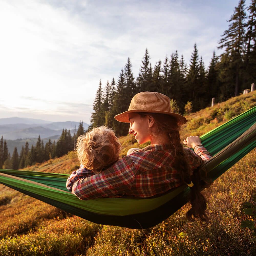 Mother and daughter in hammock in the mountains