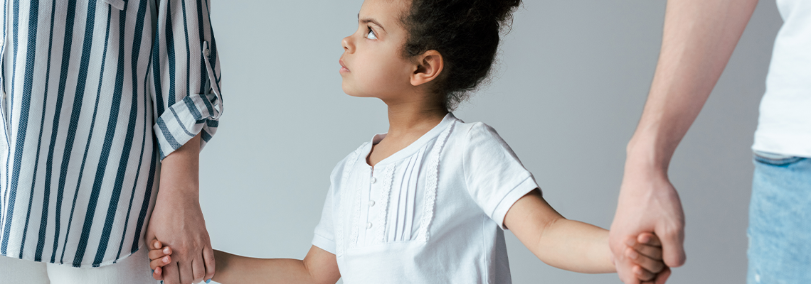 Kid holding hands with divorced foster parents