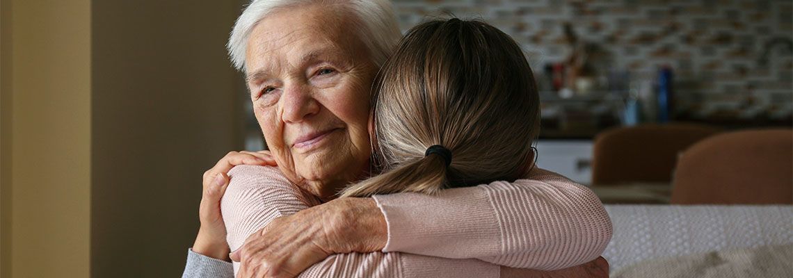Old women hugging her guardian